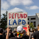 Image for article titled LAPD Officers Accused of Sharing George Floyd Valentine's Day Photo That Reads 'You Take My Breath Away'